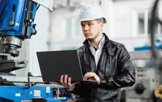 manager overseeing machine work performance