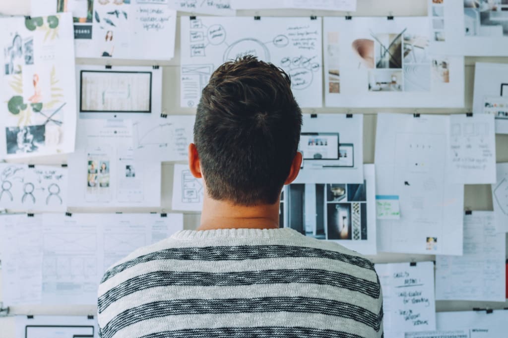 A person from the back, looking at a brainstorming board